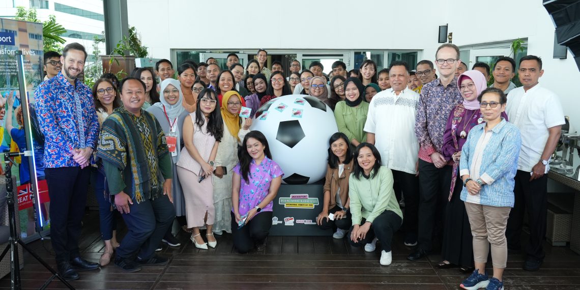 Para peserta Diskusi Komunitas Breaking Barries, Building Feature #KickOutGBV# berfoto bersama dilatari bola untuk olahraga sepak bola di Jakarta, 6 Maret 2026. (Foto: Magdalene)